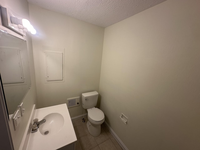 bathroom with vanity, tile patterned floors, a textured ceiling, and toilet