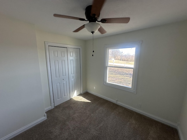 unfurnished bedroom featuring carpet floors, ceiling fan, and a closet