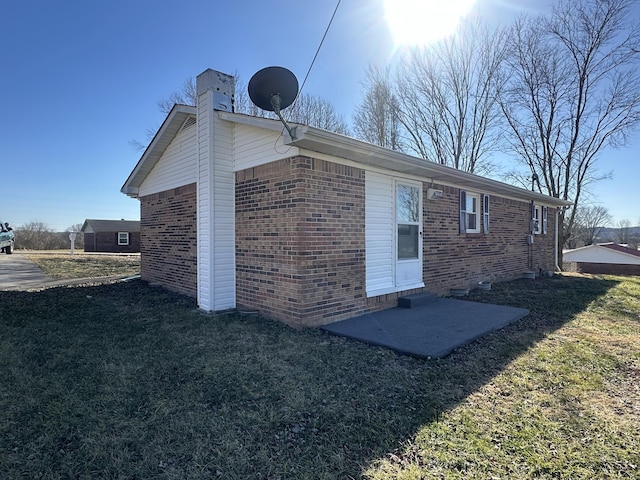 back of property featuring a yard and a patio area