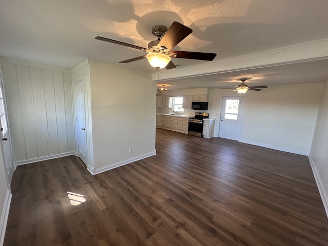 unfurnished living room featuring dark wood-type flooring, ceiling fan, and sink