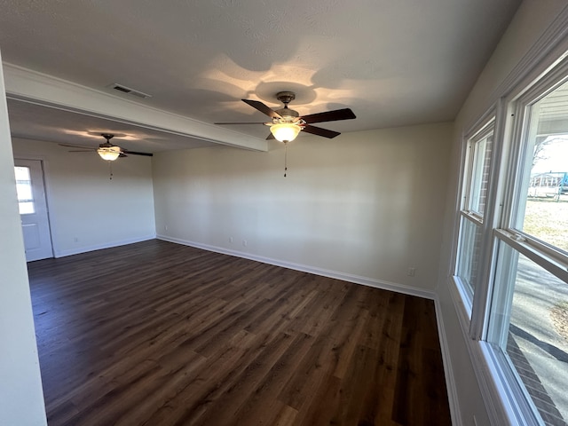 spare room featuring dark hardwood / wood-style flooring, a textured ceiling, and ceiling fan