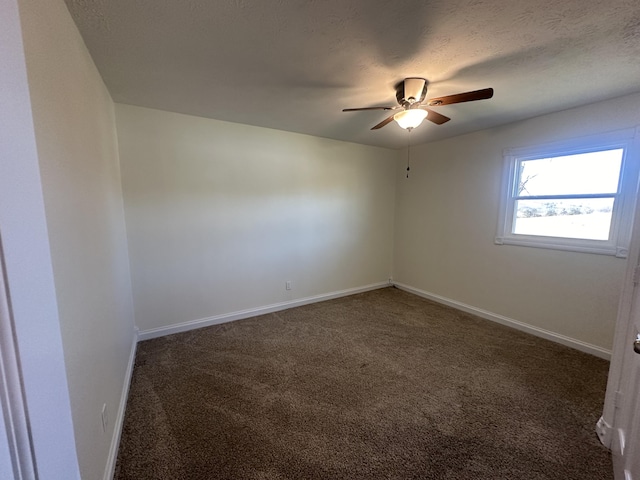 carpeted empty room featuring ceiling fan and a textured ceiling