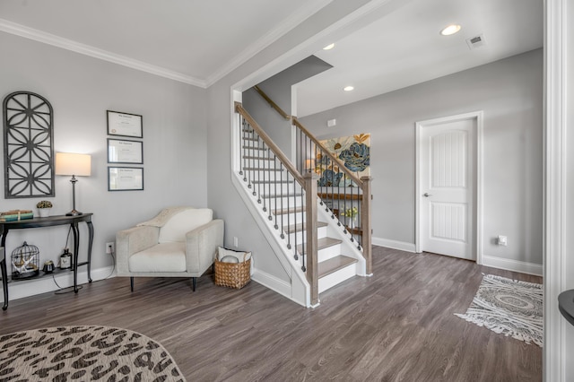 living area featuring hardwood / wood-style flooring and crown molding