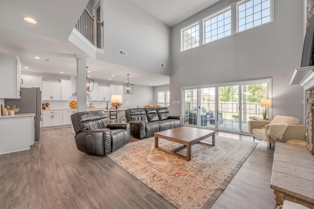 living room featuring hardwood / wood-style flooring and ornate columns