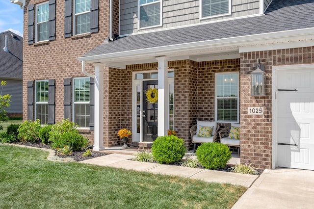 view of exterior entry featuring a lawn