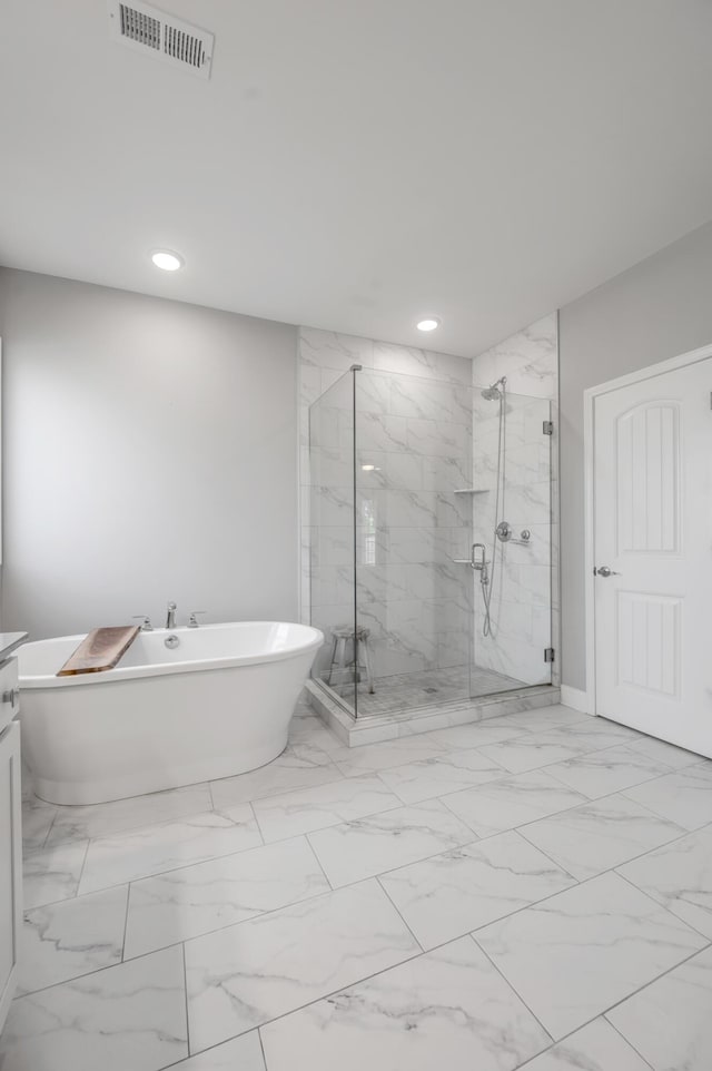 bathroom featuring vanity and separate shower and tub