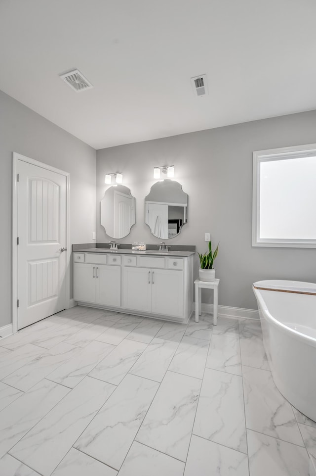 bathroom featuring vanity and a bath