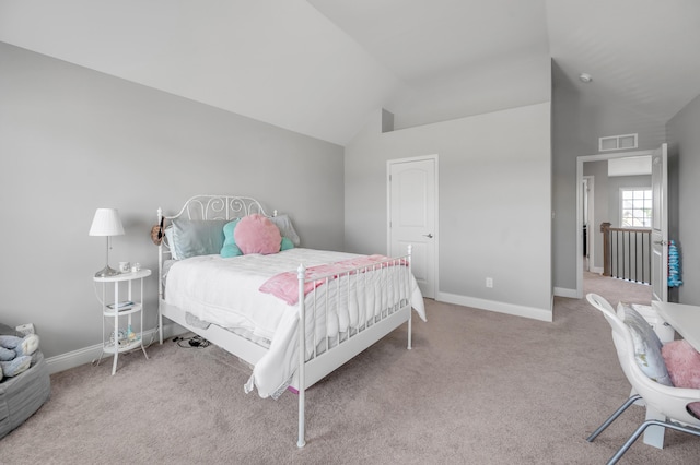 carpeted bedroom with vaulted ceiling