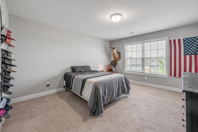 bedroom with light colored carpet