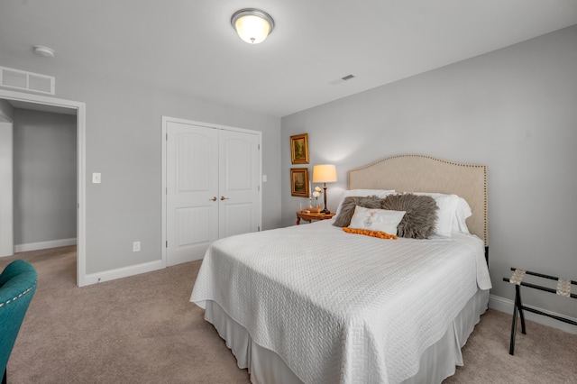 bedroom featuring light colored carpet and a closet