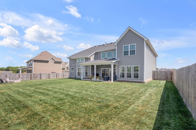 back of house with a patio and a yard