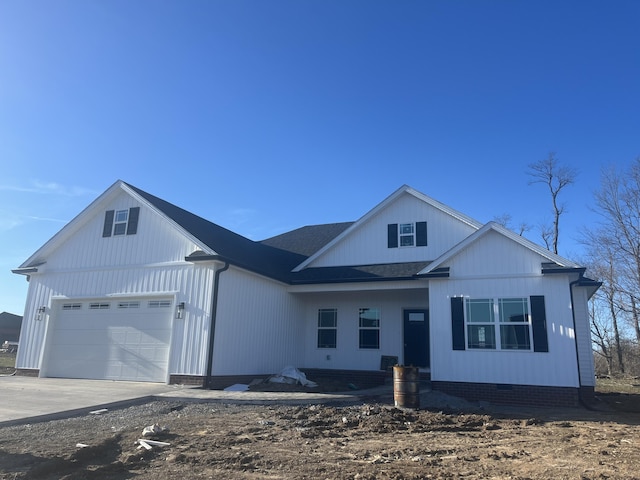 modern farmhouse with driveway, crawl space, an attached garage, and roof with shingles