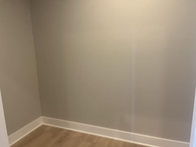 empty room featuring baseboards and wood finished floors