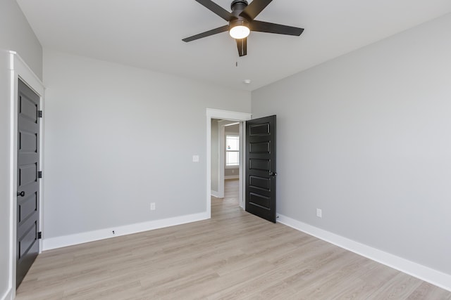 unfurnished bedroom featuring baseboards, light wood-type flooring, and a ceiling fan