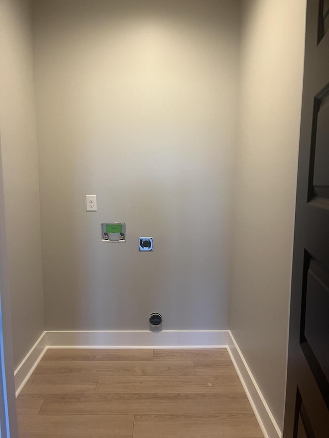 washroom with baseboards, laundry area, light wood-style flooring, electric dryer hookup, and washer hookup