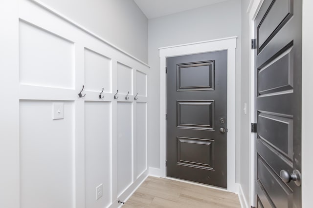 mudroom featuring light wood-style floors and baseboards