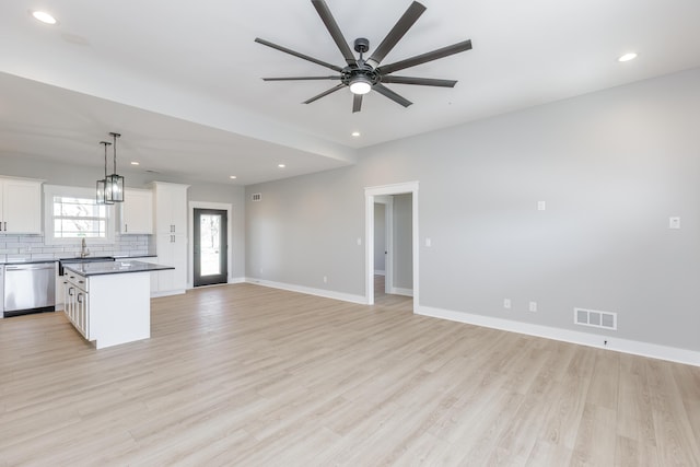 unfurnished living room featuring recessed lighting, visible vents, a sink, and ceiling fan