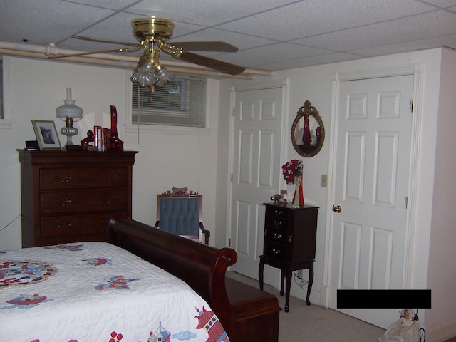 bedroom with carpet floors and a drop ceiling