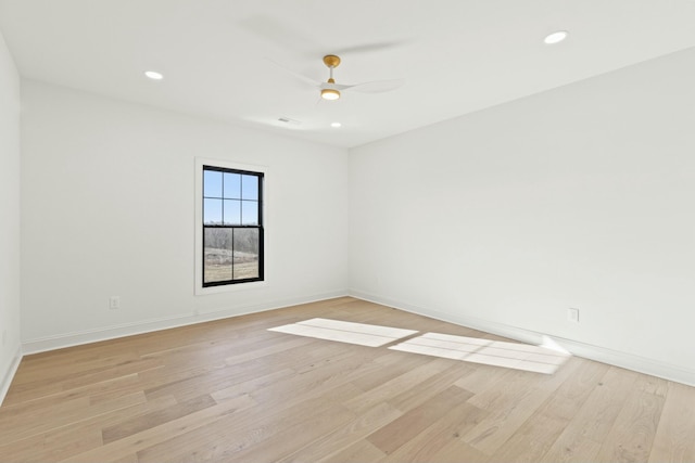 spare room featuring light hardwood / wood-style flooring and ceiling fan