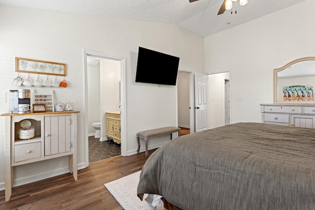 bedroom featuring hardwood / wood-style flooring, ensuite bath, lofted ceiling, and ceiling fan