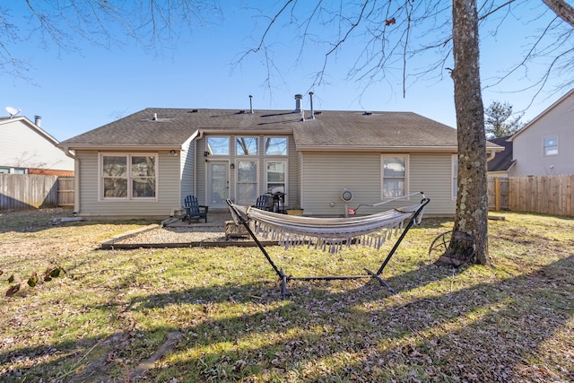 rear view of house featuring a yard