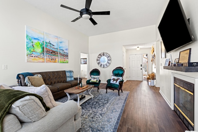 living room featuring ceiling fan and dark hardwood / wood-style flooring