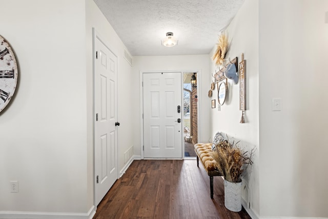 interior space with dark wood-type flooring and a textured ceiling