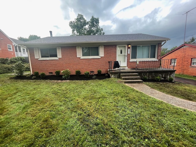 single story home featuring roof with shingles, a front lawn, crawl space, and brick siding