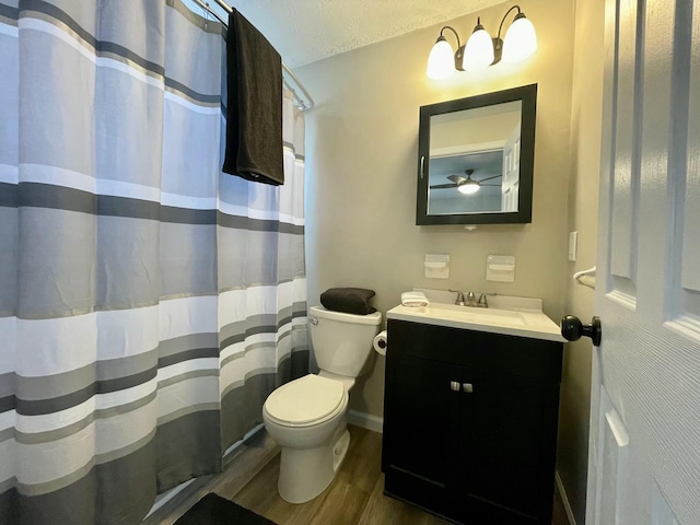 bathroom with vanity, a textured ceiling, wood-type flooring, and toilet