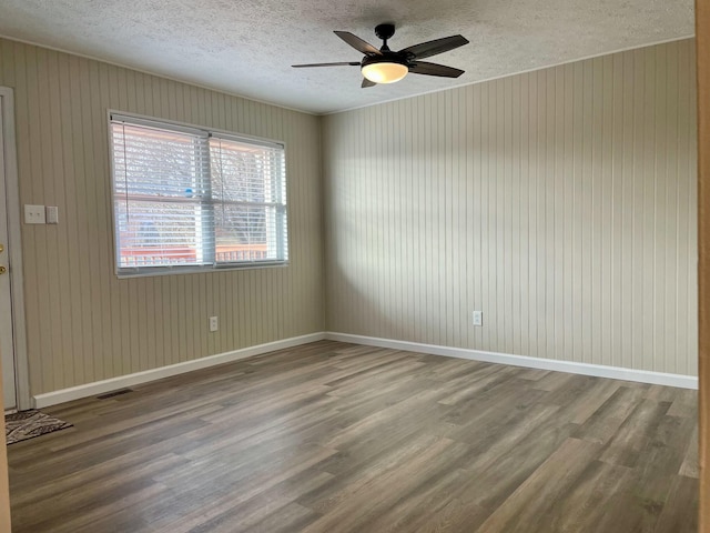 spare room with hardwood / wood-style flooring, ceiling fan, and a textured ceiling