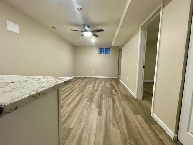 unfurnished living room with ceiling fan and light wood-type flooring