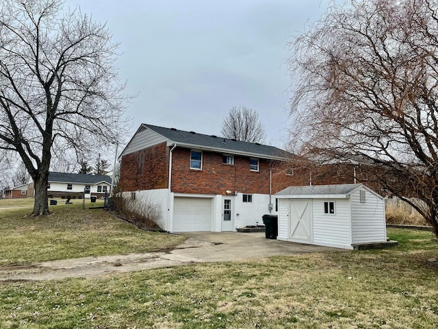 back of house with a shed, a yard, and a garage