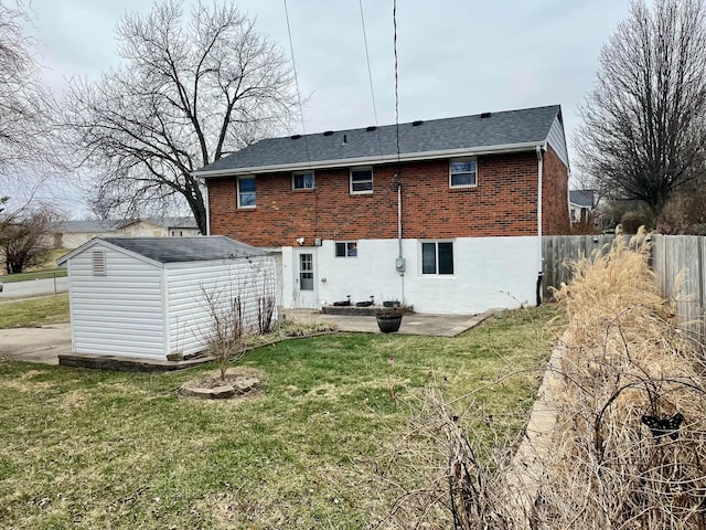 back of house featuring a yard, a storage unit, and a patio area