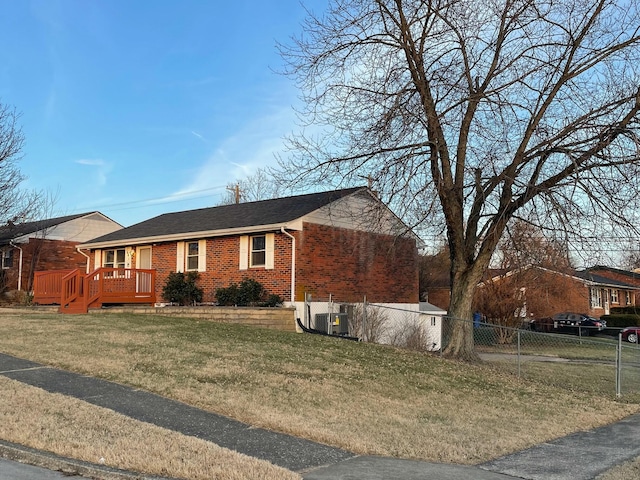 view of front of house featuring a front yard and central air condition unit