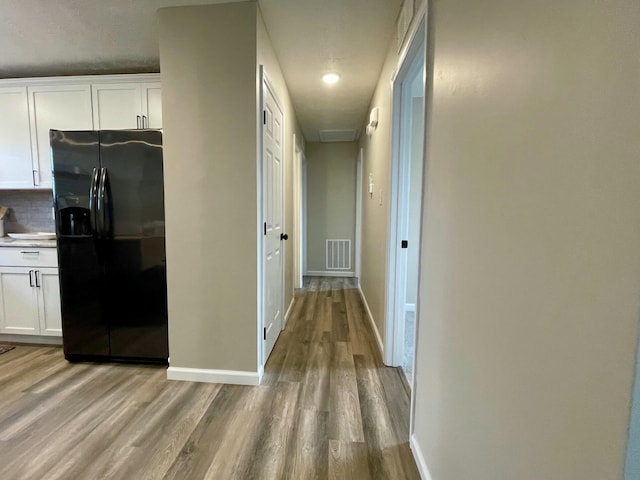 hall with light hardwood / wood-style floors