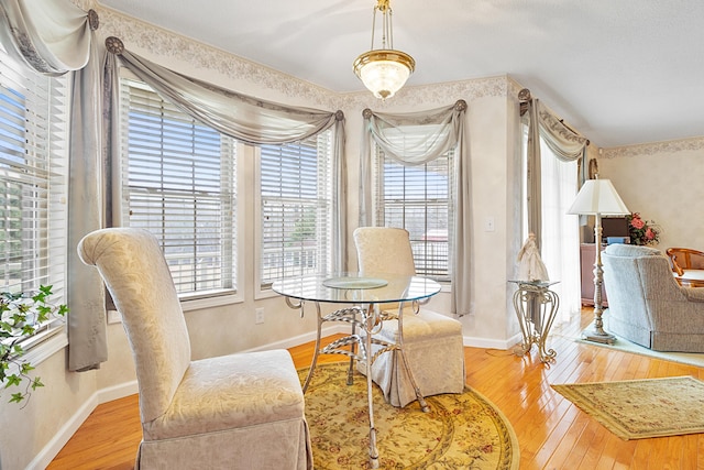 dining space featuring plenty of natural light and light hardwood / wood-style floors