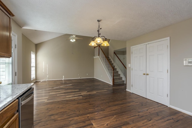 interior space with lofted ceiling, dark hardwood / wood-style floors, ceiling fan with notable chandelier, and a textured ceiling