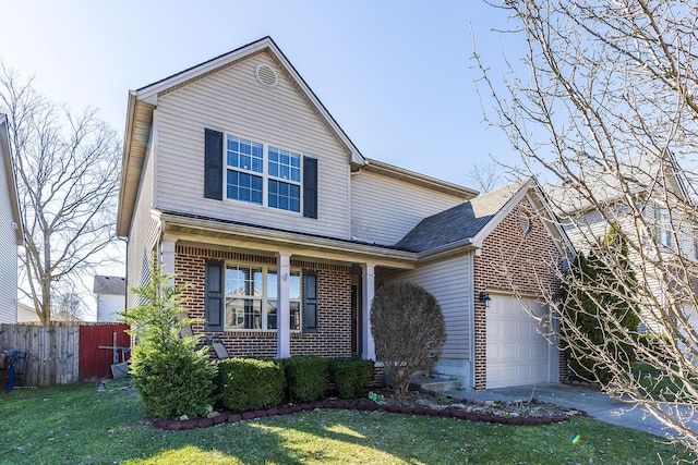 view of front facade featuring a garage, a front yard, and covered porch