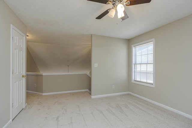 bonus room featuring light colored carpet and ceiling fan