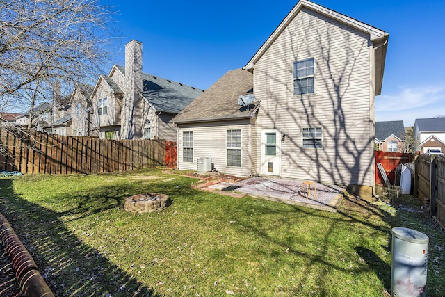 back of property featuring cooling unit, an outdoor fire pit, a lawn, and a patio area