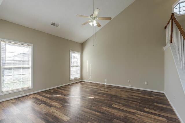 unfurnished room with high vaulted ceiling, dark hardwood / wood-style floors, and ceiling fan