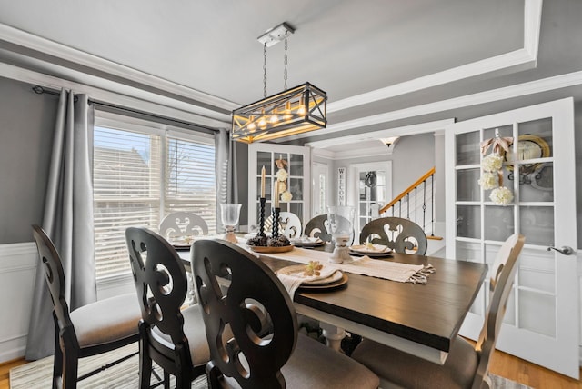 dining space featuring crown molding and light wood-type flooring