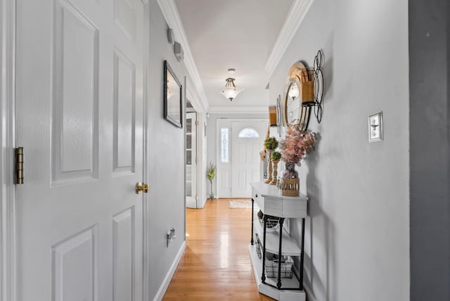 corridor with crown molding and light wood-type flooring