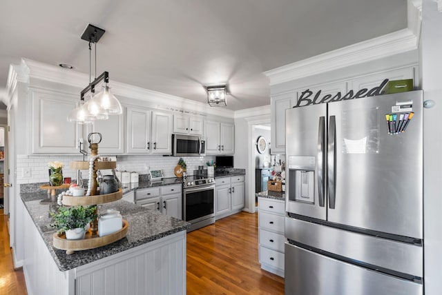 kitchen featuring dark stone countertops, appliances with stainless steel finishes, dark hardwood / wood-style floors, white cabinets, and backsplash