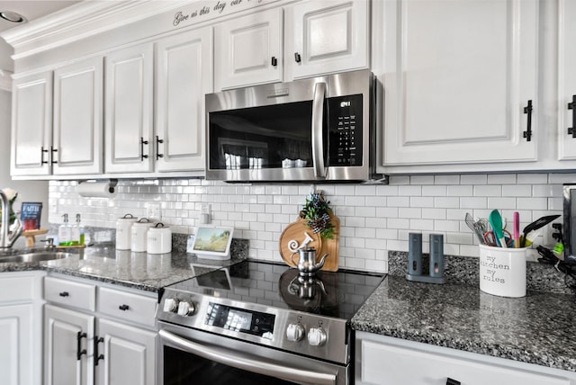 kitchen featuring sink, backsplash, stainless steel appliances, and white cabinets