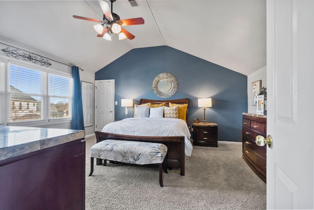 carpeted bedroom featuring lofted ceiling and ceiling fan