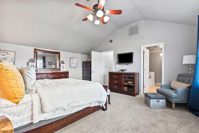 bedroom featuring vaulted ceiling, light colored carpet, ceiling fan, and ensuite bathroom