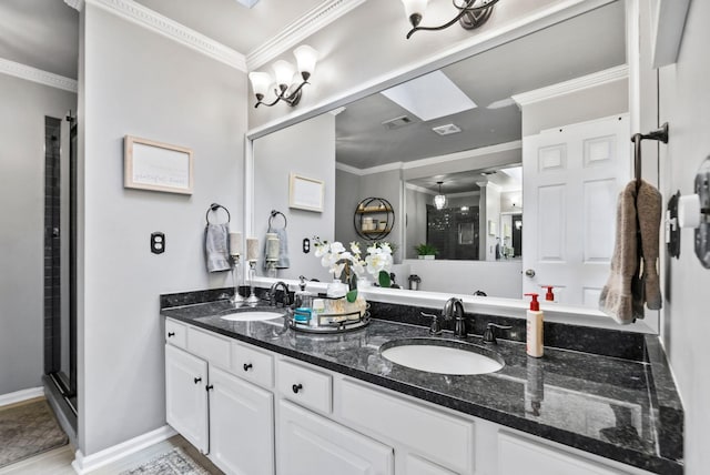 bathroom featuring vanity, a shower with shower door, and ornamental molding