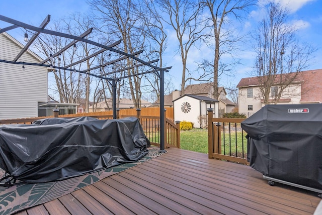 wooden deck featuring a grill and a shed