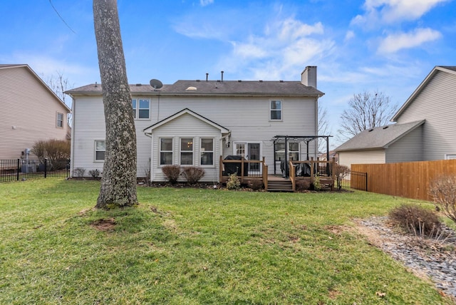 back of house featuring a pergola, a deck, and a lawn